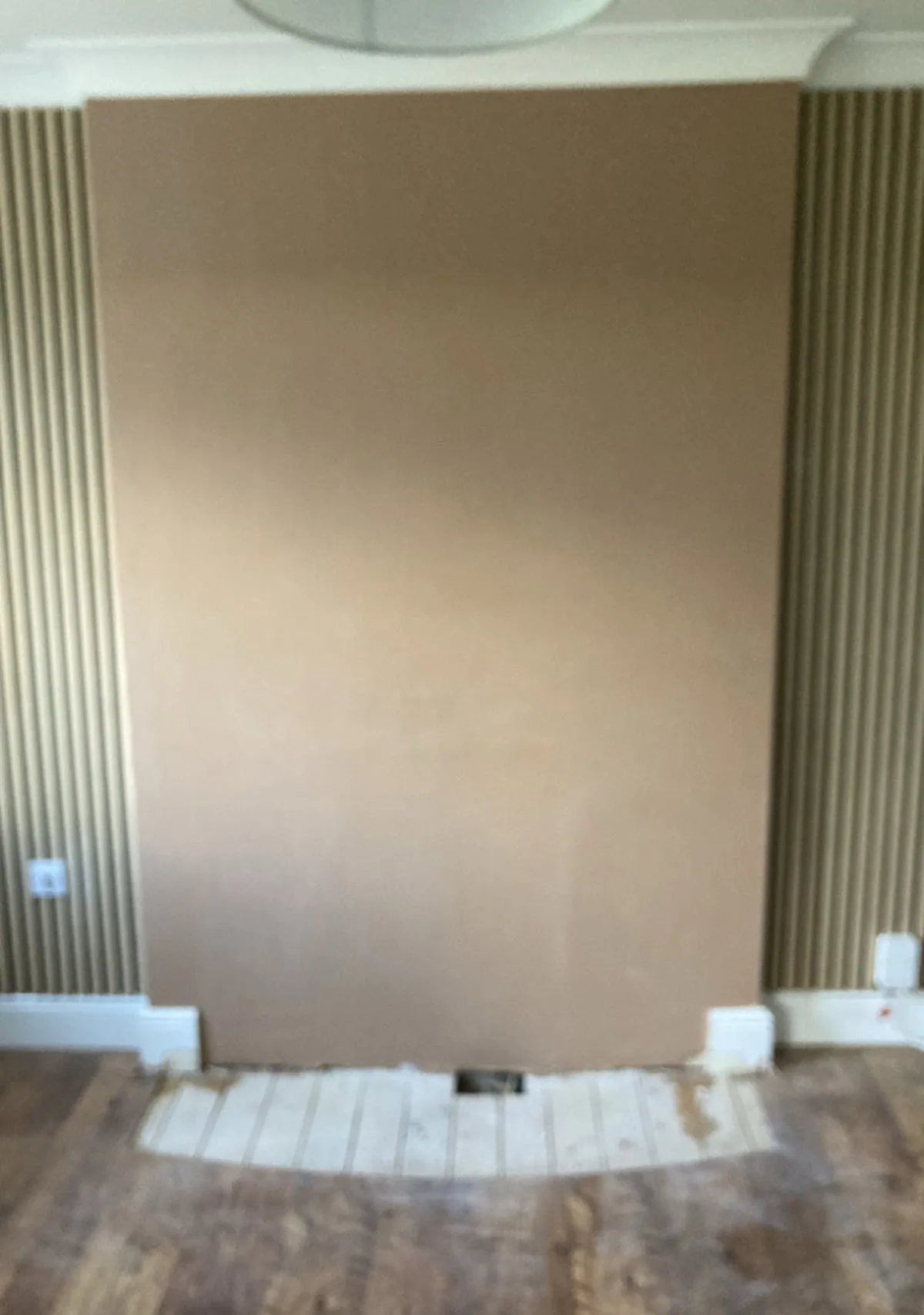 Re-skimmed wall finished smooth between two alcoves, ready for paint